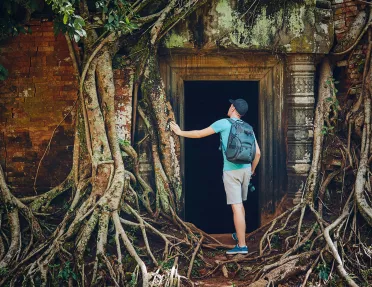 Person exploring the temple of Angkor Wat in Cambodia