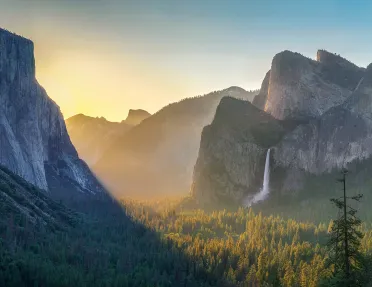 Wide shot of mountains at sunset.