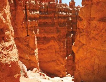 Hikers walking along rock formations