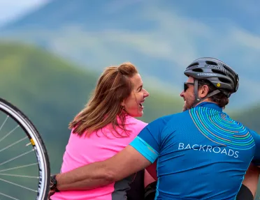Backroads guests embracing one another after bike ride