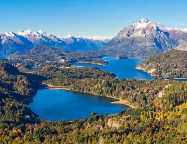 Multiple lakes surrounded by tall trees and mountains