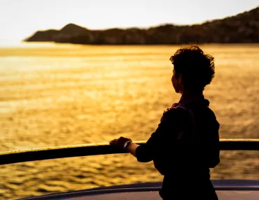 Person on a beach looking into the sunset