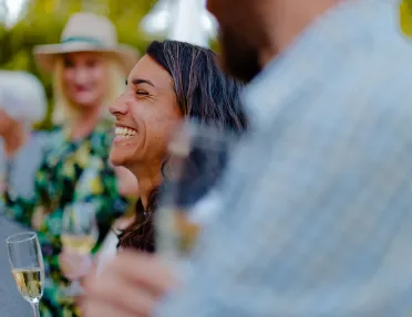 Woman smiling while holding up a glass of wine