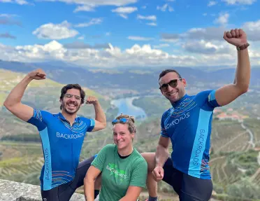 Two men and one woman flexing their muscles