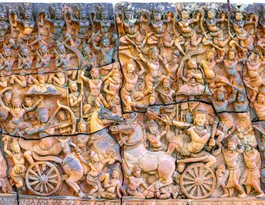 Carved statue of people with horse and carriages