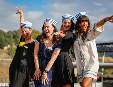 Group of 4 women smiling while wearing sailor hats