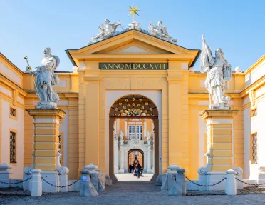 Historic castle with carved statues on a pillar