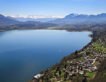 A large lake surrounded by houses and mountains