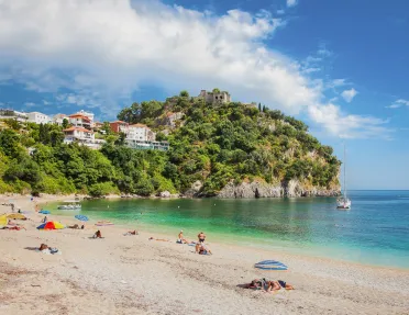 Sunny beach with a cliff in the distance