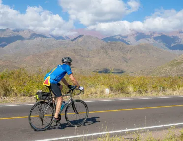 person biking down a road
