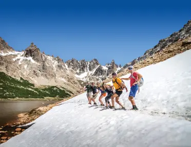 Group of hikers standing on snowy path