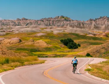 Backroads guest biking down a road
