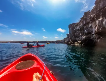 The top of a kayak in a blue lake