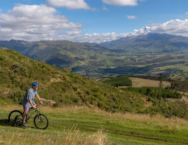 Biker cycling across a large field