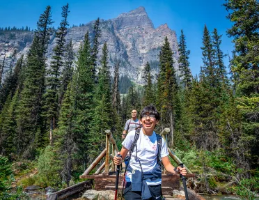 Backroads guest hiking across a bridge