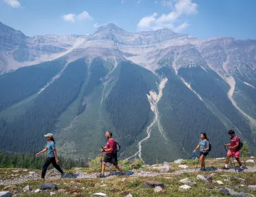 backroads guests hiking by a mountain