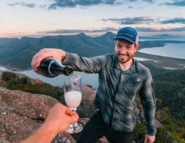 Man pouring alcohol into a small glass