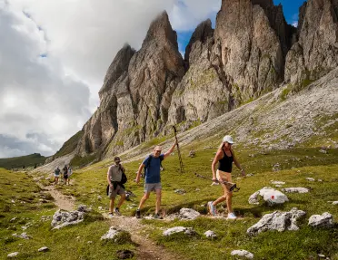 Hikers walking up a path near mountains