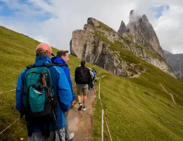 Hikers walking trail towards mountain