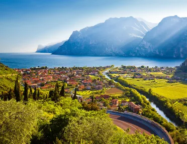 Small oceanside town with crop fields and mountains