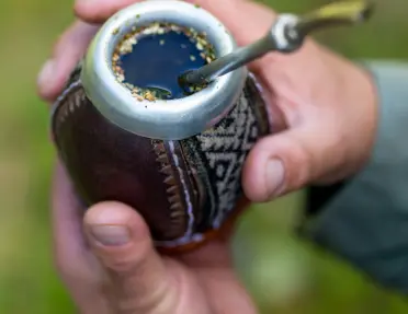 Traditional mate drink, in a small cup with a metal straw sticking out