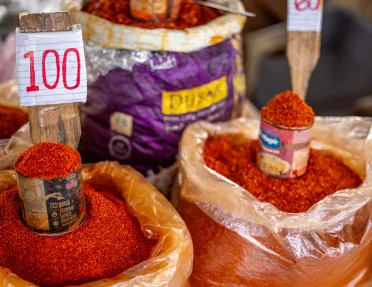 Bags of chili powder with cans for scooping on top