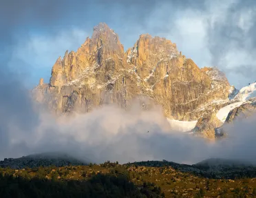 Large, jagged mountain covered in fog, with a large valley on the ground floor