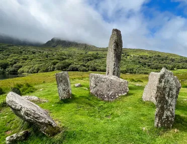 six large rocks in a grassy field