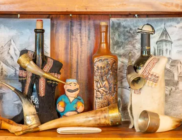 Shelf full of ivory tusks and wooden carved statues