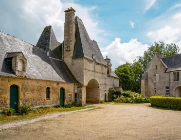 Rustic, stone church building with a dirt valley in front