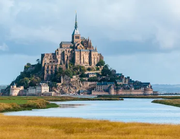 Castle-like cathedral building on an island, surrounded by ponds of water