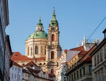 Large, castle-like building in the distance of a small town