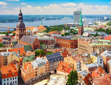 Sky view of a European town with orange apartment building and a large river in the background