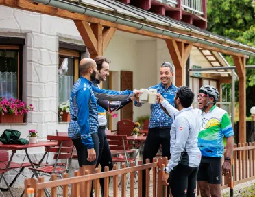 Group of men raiding beer steins and smiling