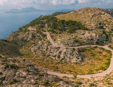 Long, sharp-turned road on an open valley