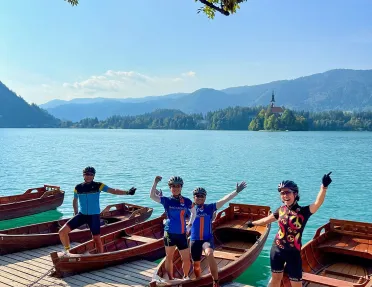 Group of people standing on wooden boats by a large lake