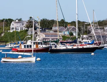 Cluster of boats floating in the water by a dock