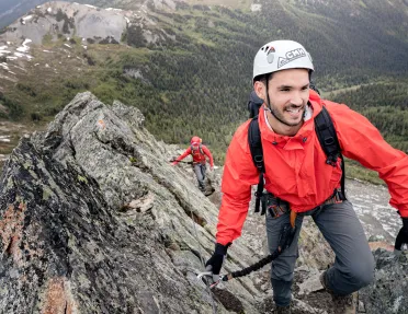 Backroads guests scaling a rocky mountain terrain