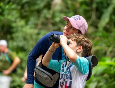 Mom and son looking through a pair of binoculars