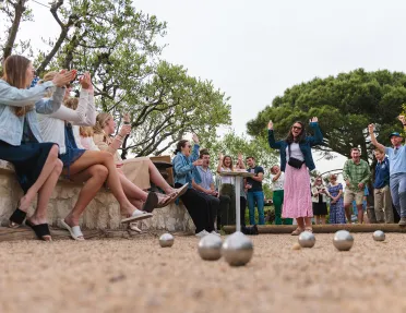 Group of people laughing while playing bocce ball