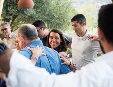 Group of people hugging and dancing