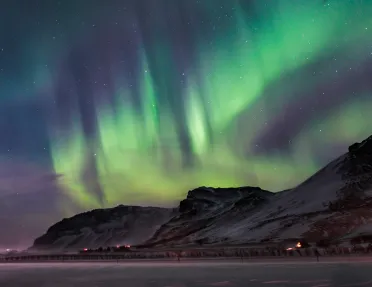 Snowy mountains with an aurora in the sky