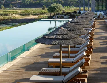Reclining chairs in front of an infinity pool