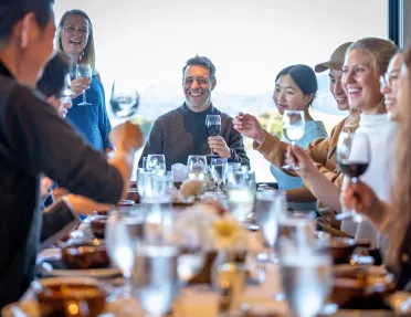 Backroads guests gather celebrate around a dinner table