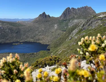 Large mountains covered in plants with a lake in the center