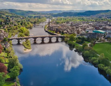 River cutting between a town with a bridge in the center
