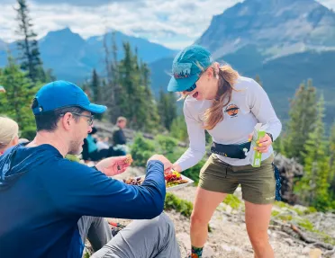 Woman passing a plate of snacks to a man