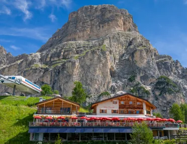 Wooden cabin building with a large mountain in the back
