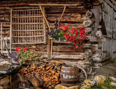 Wooden cabin with flower pots hanging outside