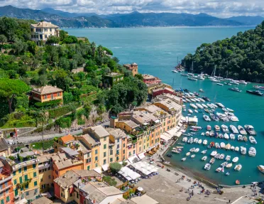 Sky view of a row of buildings in front of a boat dock